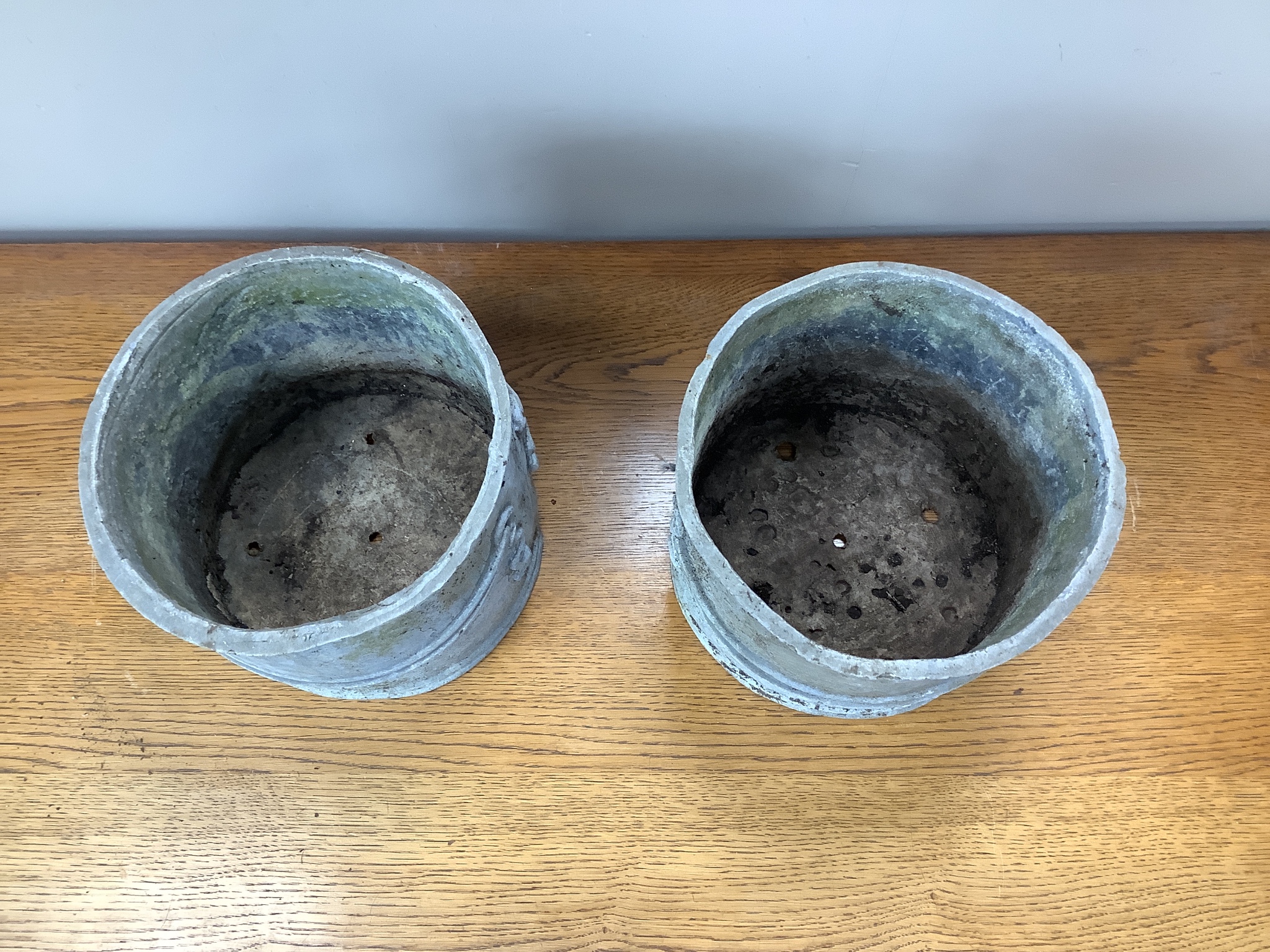 A pair of circular lead garden planters, 23cm diameter, height 20cm